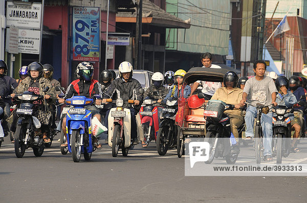 Rickshaw driver in road traffic  Jogyakarta  Central Java  Indonesia  Southeast Asia  Asia