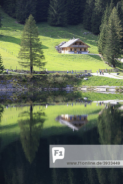 Hut on the Klacklalm alpine pasture reflected in Lake Gosau  Salzkammergut  Upper Austria  Austria  Europe