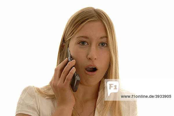 Eighteen year old woman with a mobile phone  looking puzzled