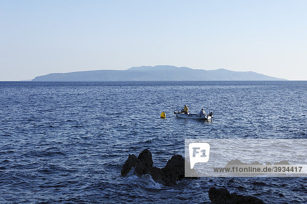 Fishermen in a boat  Cres Island  view from Ika  Istria  Kvarner Gulf  Croatia  Europe