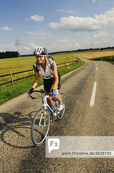 Young woman riding a bicycle  Bavaria  Germany  Europe