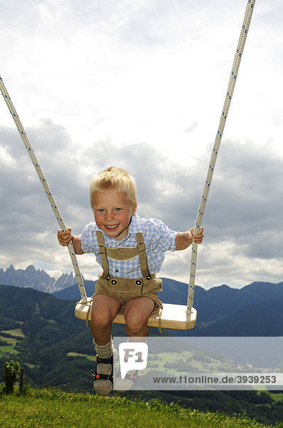Boy on a swing  Odle group  Dolomites  South Tyrol  Italy  Europe