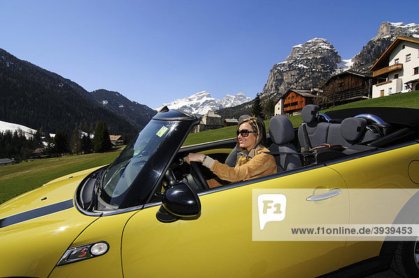 Woman driving Mini Cooper at the Gardena Pass  Alpine pass  South Tyrol  Italy  Europe