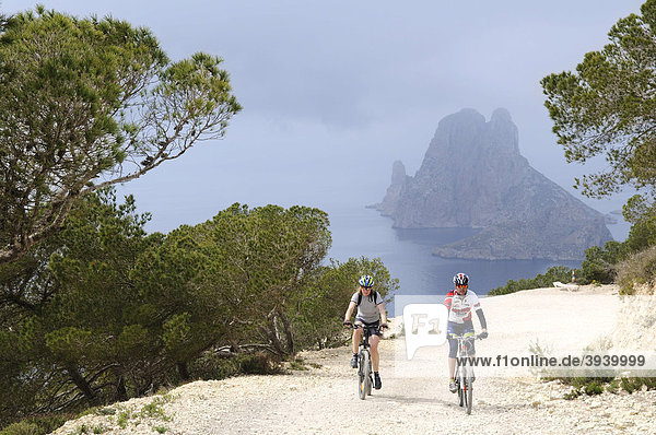 Mountain bikers at Cap Blanc  Es Vedra island  Ibiza  Pine Islands  Balearic Islands  Spain  Europe