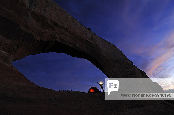 Tent  hiker  trekking  Wilson Arch  Moab  Utah  USA