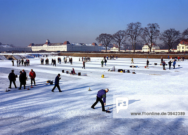A game of Ice stock  Bavarian Curling  on the frozen lake of Nymphenburg Palace  Munich  Upper Bavaria  Germany  Europe
