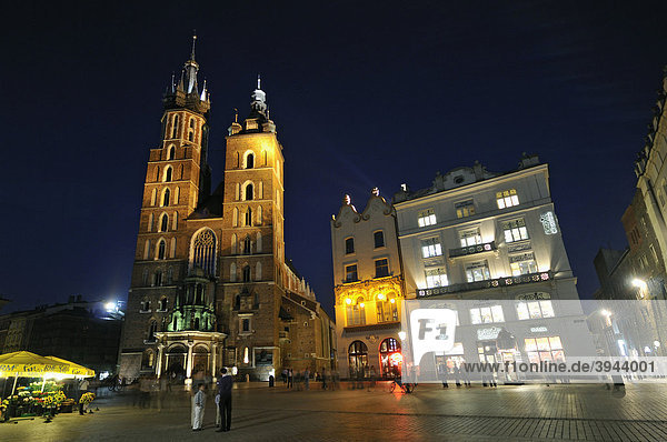 Gothic St. Mary's Basilica Church  Kosciol Mariacki  and townhouses by night  Main Market Square  Rynek Glowny  in Krakow  Cracow  Poland  Europe
