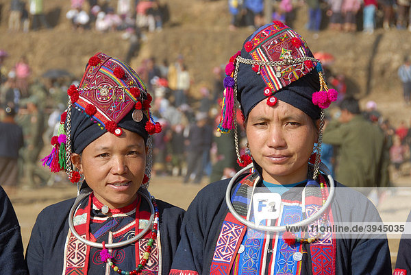 Portrait  ethnology  two women of the Akha Oma ethnicity dressed in colorful dresses  headdresses  festival in Phongsali city  Phongsali province  Phongsaly  Laos  Southeast Asia  Asia