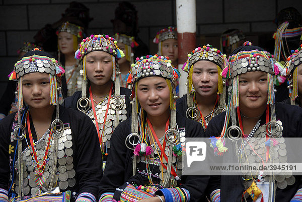 Group picture  girls of the Akha Nuqui ethnic group  traditional clothes  hats decorated with silver coins  Phongsali province  Laos  Southeast Asia  Asia