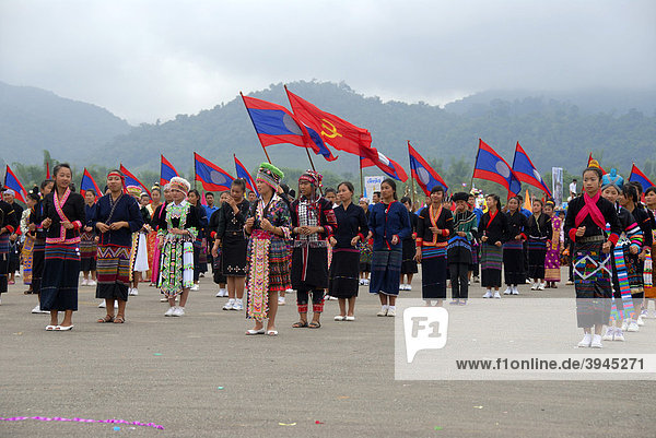 Festival  Laotian people of different ethnic groups  Khmu  Hmong  Akha  Lue  Lao National flags  flags of the Communist Party  Muang Xai  Udomxai province  Laos  Southeast Asia  Asia