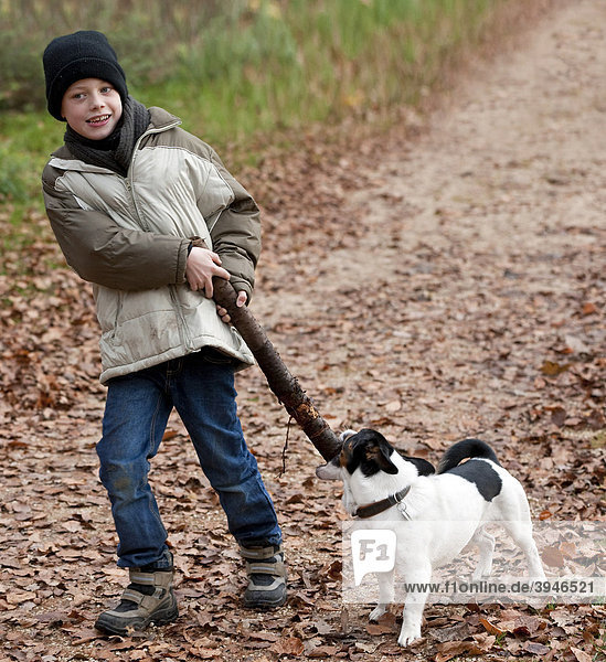 Ein Junge  7 Jahre  spielt mit seinem Hund