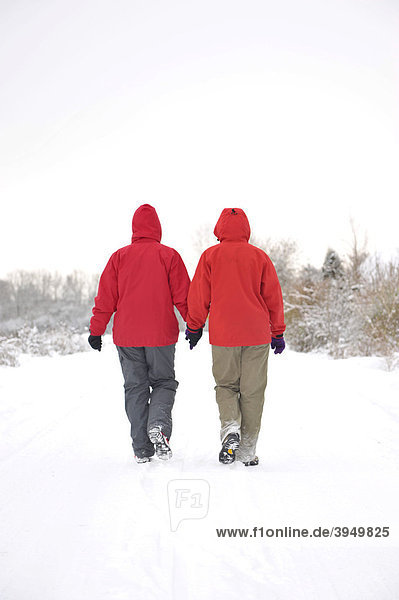 Two hikers walking through the snow