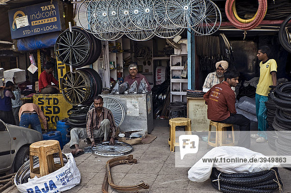Street scene  shops selling bike accessories  tires  wheels  etc.  Old Delhi  India  Asia