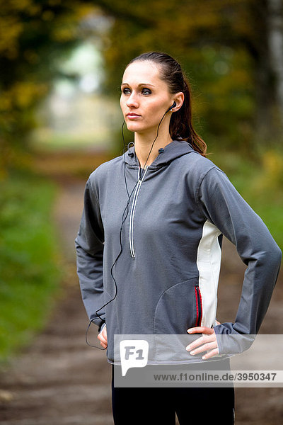 Young woman warming up before jogging