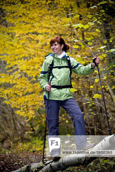 Woman hiking through a forest in autumn