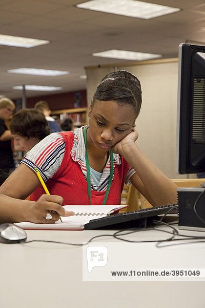 A student studies in the media center  library  at Lake Shore High School  St. Clair Shores  Michigan  USA