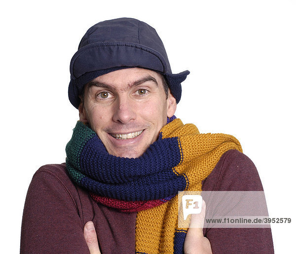 Young man feeling the cold  wearing a big colourful scarf and winter hat