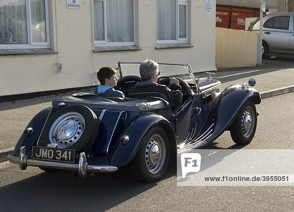 Man and boy in vintage car  Cornwall  England  UK  Europe