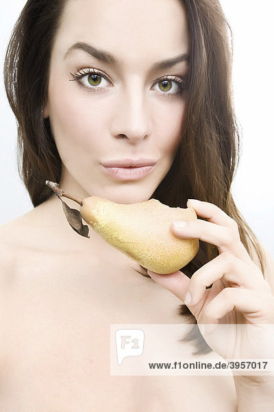 Healthy pretty woman eats pear