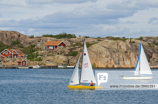 Segelboote und rote Holzhäuser bei Fjällbacka  Bohuslän  Schweden