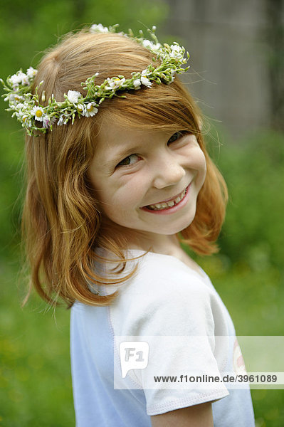 Young girl wearing a floral wreath in her hair