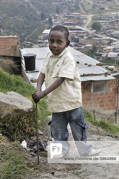 Six year old dark-skinned boy  slums of Alto de Cazuca  Soacha  Bogot·  Columbia