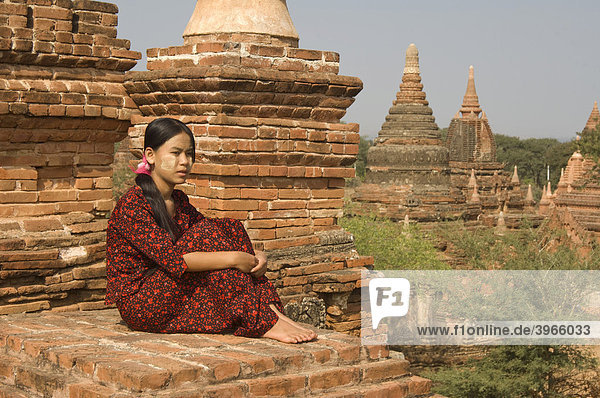 Young Burmese woman on the roof of a temple  Bagan  Myanmar  Burma  Southeast Asia