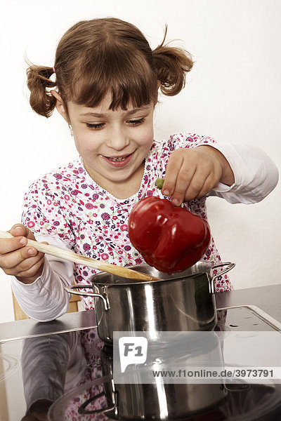 Six-year-old girl playing in the kitchen