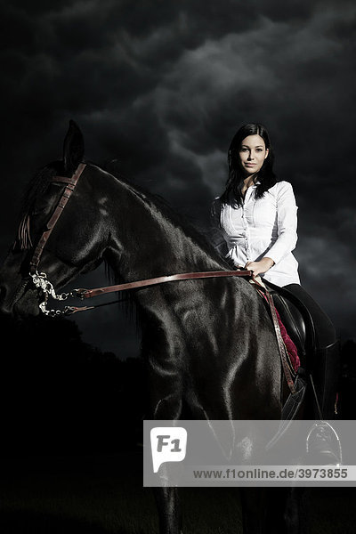 Young woman riding her horse