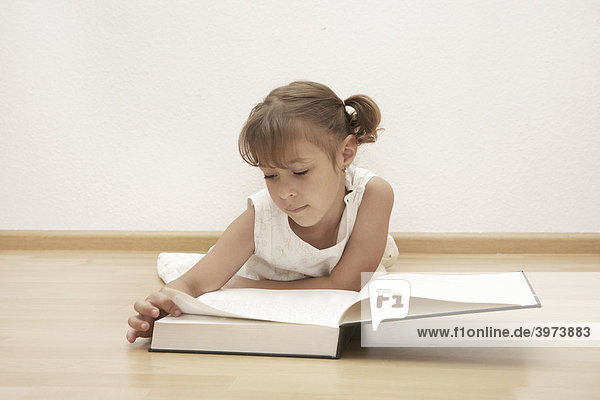 Six-year-old girl reading a book