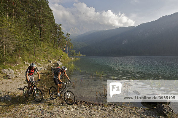 Male and female mountainbike riders at Eibsee Lake  Grainau  Upper Bavaria  Bavaria  Germany  Europe