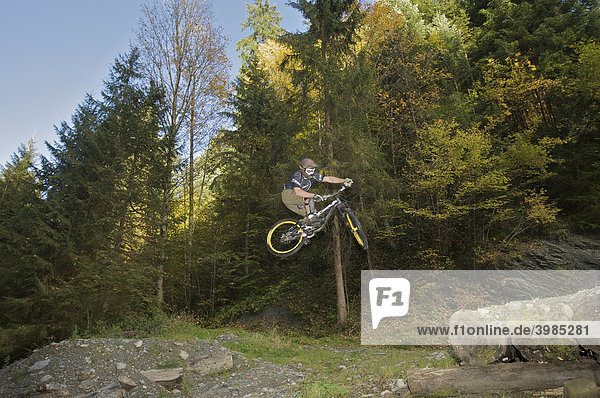 Mountainbiker jumping on a downhill track at Hopfgarten in the Brixental valley  Tyrol  Austria  Europe