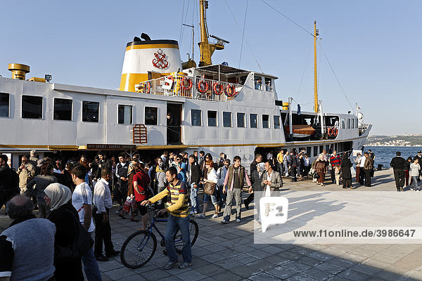 People are leaving a ferry at Kabatas  Bosphorus  Istanbul  Turkey