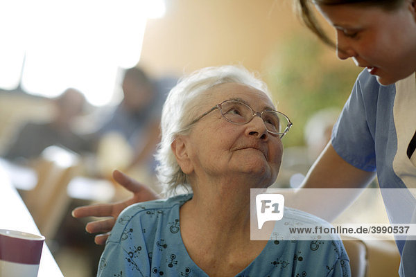 Nursing home elderly woman with a nurse