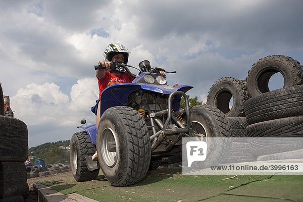 Child riding a quad bike Hesse Germany Europe