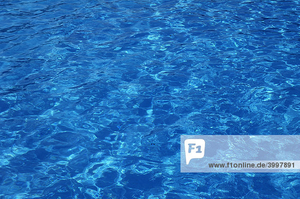Blue  clear and wavy water in an outdoor pool