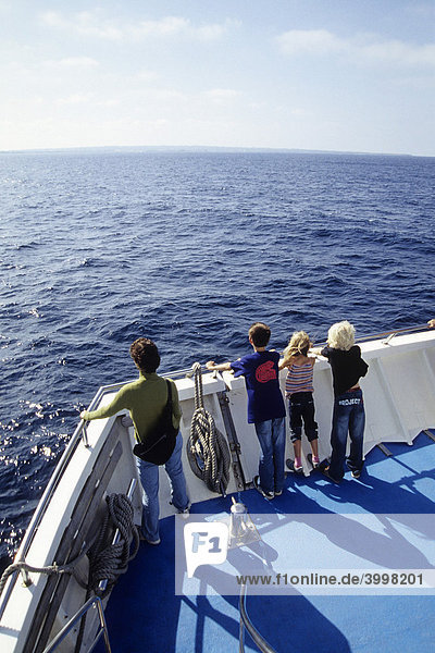 Passengers on the bow of a ferry between the Ibiza and Formentera islands  Ibiza  Balearic Islands  Spain  Europe