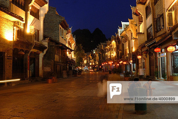 Street scenery with shops at dusk  Zhenyuan  Guizhou  China