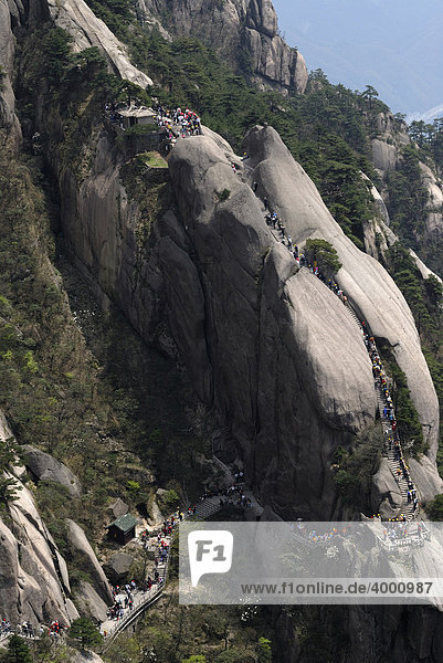 People  hikers on the stone stairs to the western sea in the mountains of Huangshan  Turtle Peak  Huang Shan  Anhui  China  Asia