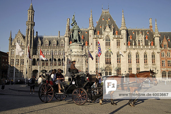 Carriage with tourists on the Grote Markt square with Provinciaal Hof Provincial Court building in the historic center of Bruges  Belgium  Europe