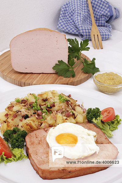 Leberkaese with fried egg and fried potatoes  Bavarian speciality