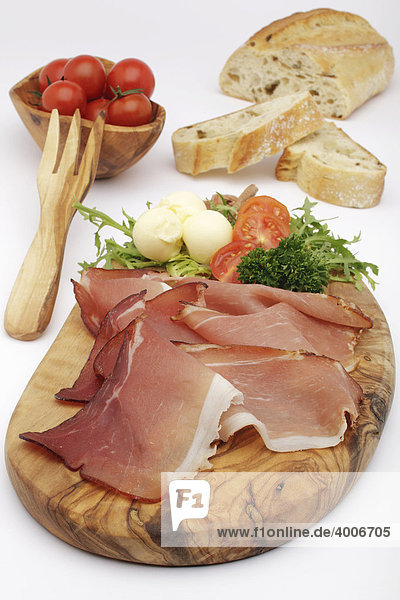 Raw ham with butter  tomatoes  olives and Italian white bread