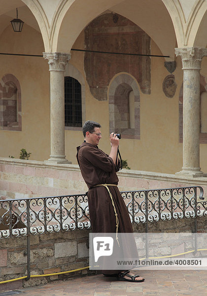 Fotografierender Mönch im Kreuzgang des Kloster San Francesco in Assisi  Umbrien  Italien  Europa