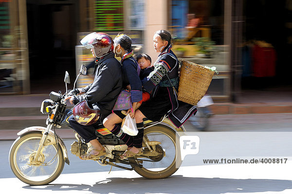 Four Vietnames people on a moped  Sapa  Hanoi  North Vietnam  Southeast Asia