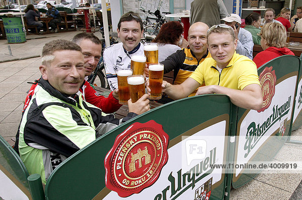 Cyclists drinking Pilsner Urquell beer in a beer garden on the Square of the Republic in Pilsen  Plzen  Bohemia  Czech Republic  Europe