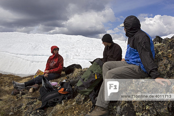 Group of hikers resting  Mt. Lorne  Pacific Coast Ranges behind  Yukon Territory  Canada  North America