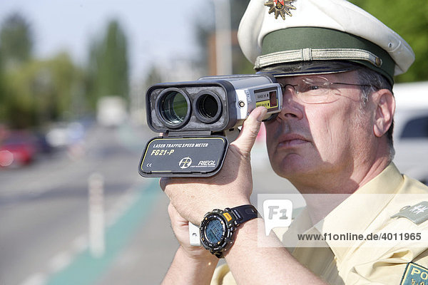 A police officer doing speed monitoring with a laser gun  Koblenz  Rhineland-Palatinate  Germany  Europe