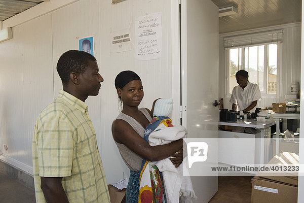 A family with a child in a hospital dispensary buying medication  Quelimane  Mozambique  Africa