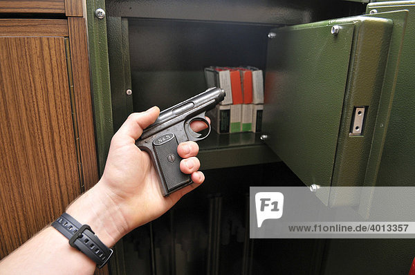 Teenager taking a pistol out of weapon locker