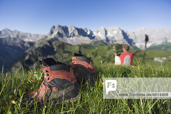 Hiking shoes and a mountaineer in front of the Karwendel Mountains  North Tyrol  Austria  Europe